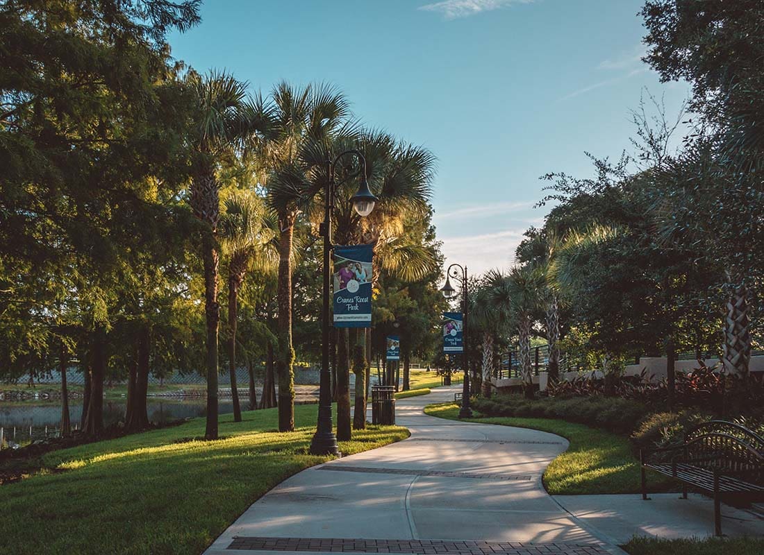 Altamonte Springs, FL - Beautiful Park with a Concrete Walkway and Palm Trees on a Sunny Day in Altamonte Springs Florida